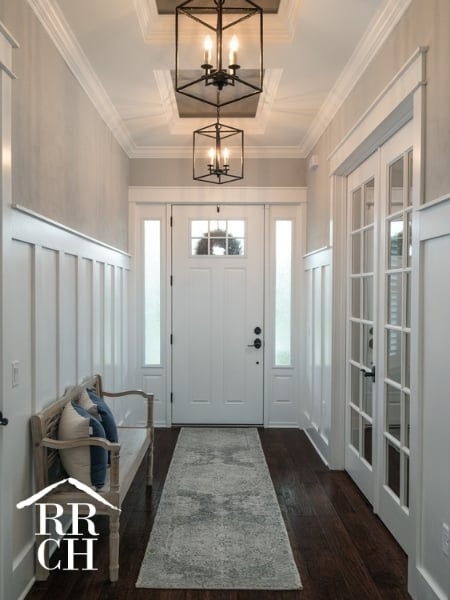 Custom Home Build Longleaf Entryway Hall with Bench Seating and Modern Industrial Light Fixtures and French Doors | Robinson Renovation & Custom Homes, Inc.
