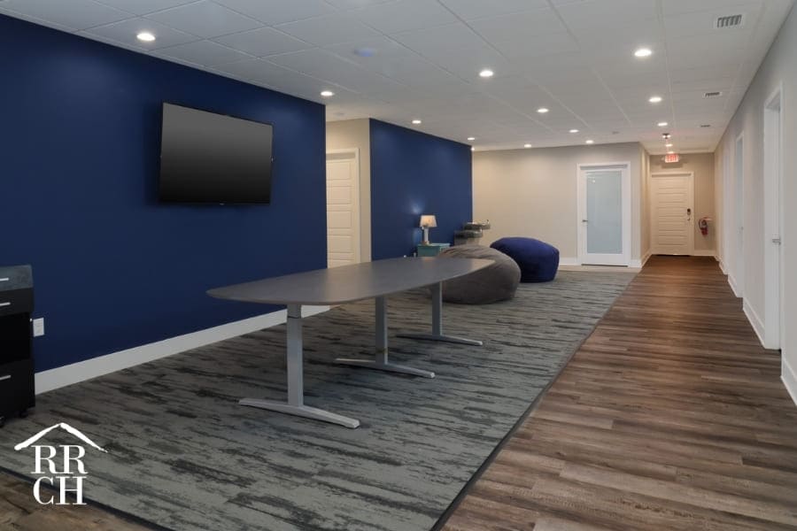 Office Remodel Commercial Renovation Project with Blue Accent Walls and Hardwood Flooring and Carpeted Area | Robinson Renovation and Custom Homes