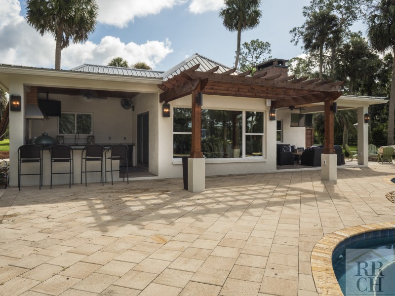 Full Outdoor Kitchen and Dining Area Next to Pool in Gainesville