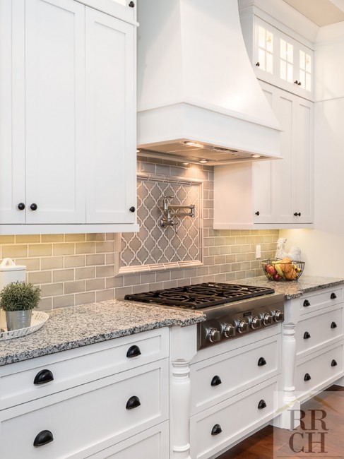 Gas Cooktop and Custom Backsplash with White Cabinets 